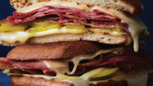 Stacked ham and cheese grilled panini made with Tillamook Cheese. 