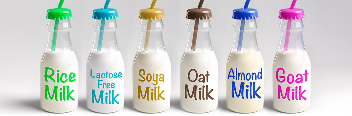Group shot of a variety of plant-based milk flavors.
