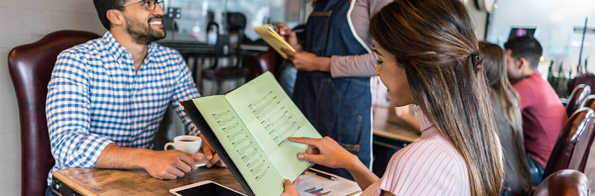 Patrons using physical menus over QR codes.