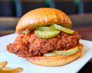 Loyal Tavern - Dish Around Town Creator Brandon Amato Close-up of a plated Nashville Hot Chicken Sandwich