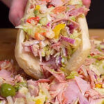 Combination of Italian sub ingredients transformed into a flavorful salad inside a traditional hoagie.