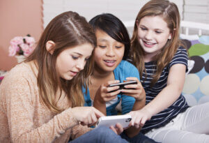 Group of Gen Alphas on their phones looking at social media.