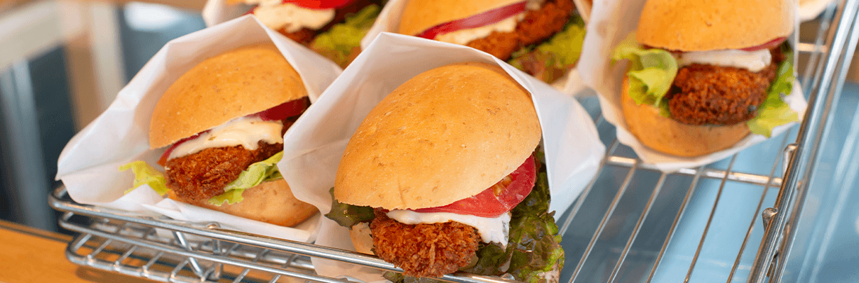 Medal tray of multiple Dave's Hot Chicken sliders for office catering.