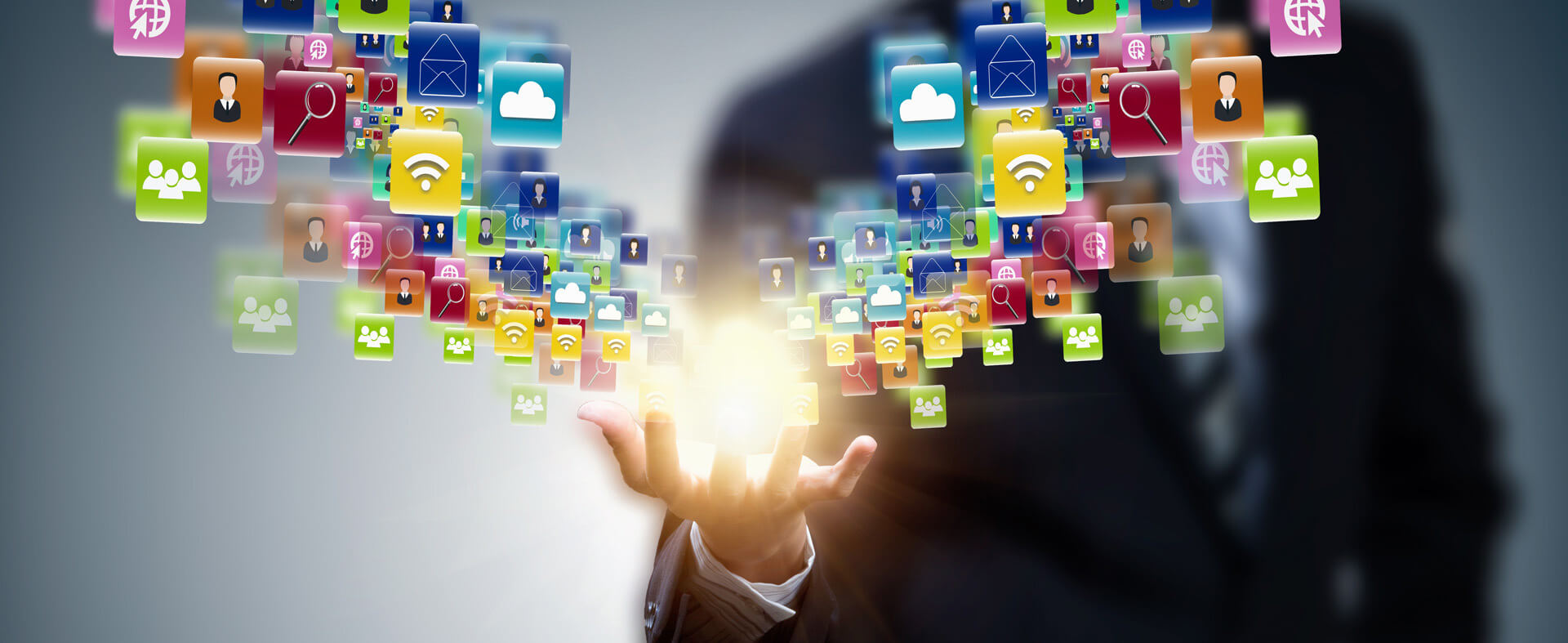 Right hand of man with a burst of social and data sharing icons.