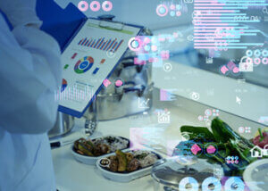 Arm of a chef holding a clipboard with data and analytics graphics overlaying an image of food.