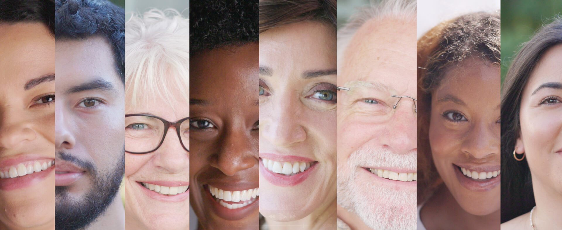 A grouping of different human faces in a row with varying ages, ethnicities and genders.