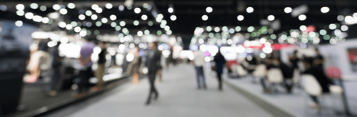Blurred image of people walking between booths at the National Restaurant Association Show