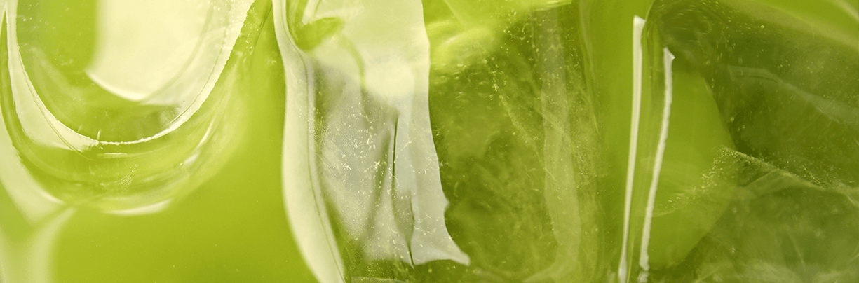 Close-up of ice cubes suspended in vibrant iced matcha green tea, illustrating this week's top foodservice stories on beverage trends at the NRA Show.