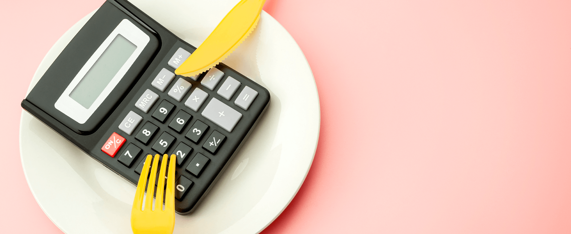 Doing the margin math: A calculator on a plate with a fork and a knife.