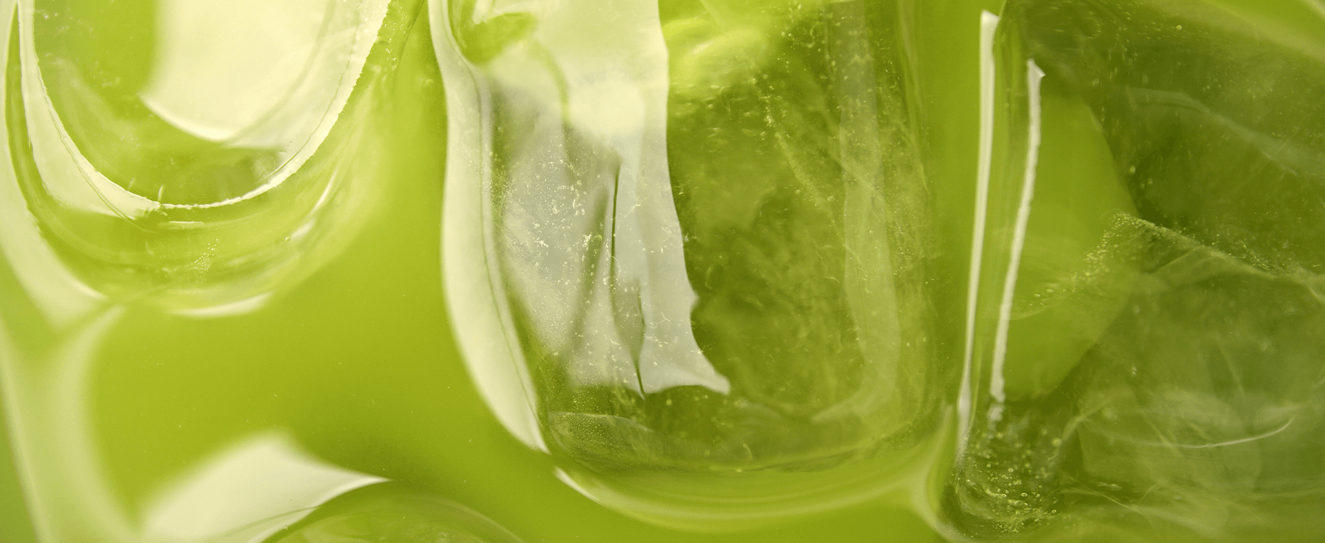 Close-up of ice cubes suspended in vibrant iced matcha green tea, illustrating this week's top foodservice stories on beverage trends at the NRA Show.