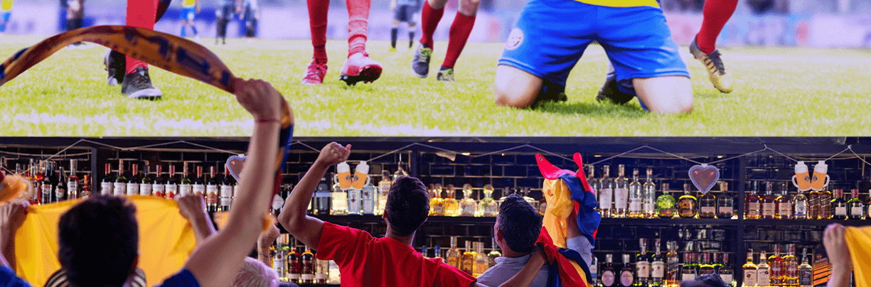 World Cup fans at a bar are watching the soccer game on a big screen.