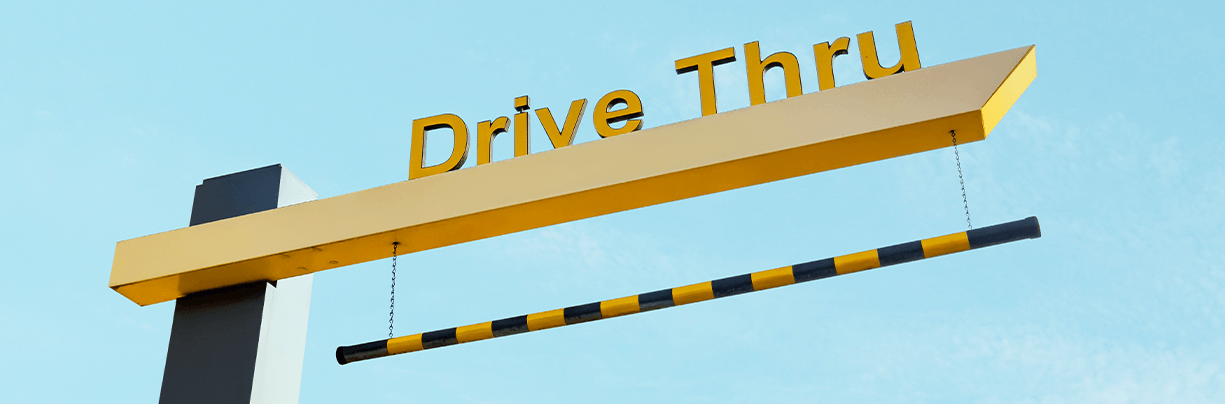 A wide-angle view of a McDonald's drive-thru lane, representing this week’s top foodservice stories about industry reinvention and structural transformation.