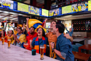 World Cup fans at a bar or restaurant cheering on their team while watching the game. One of this week's top foodservice stories: The World Cup will generate $7.5 Billion in foodservice revenue.
